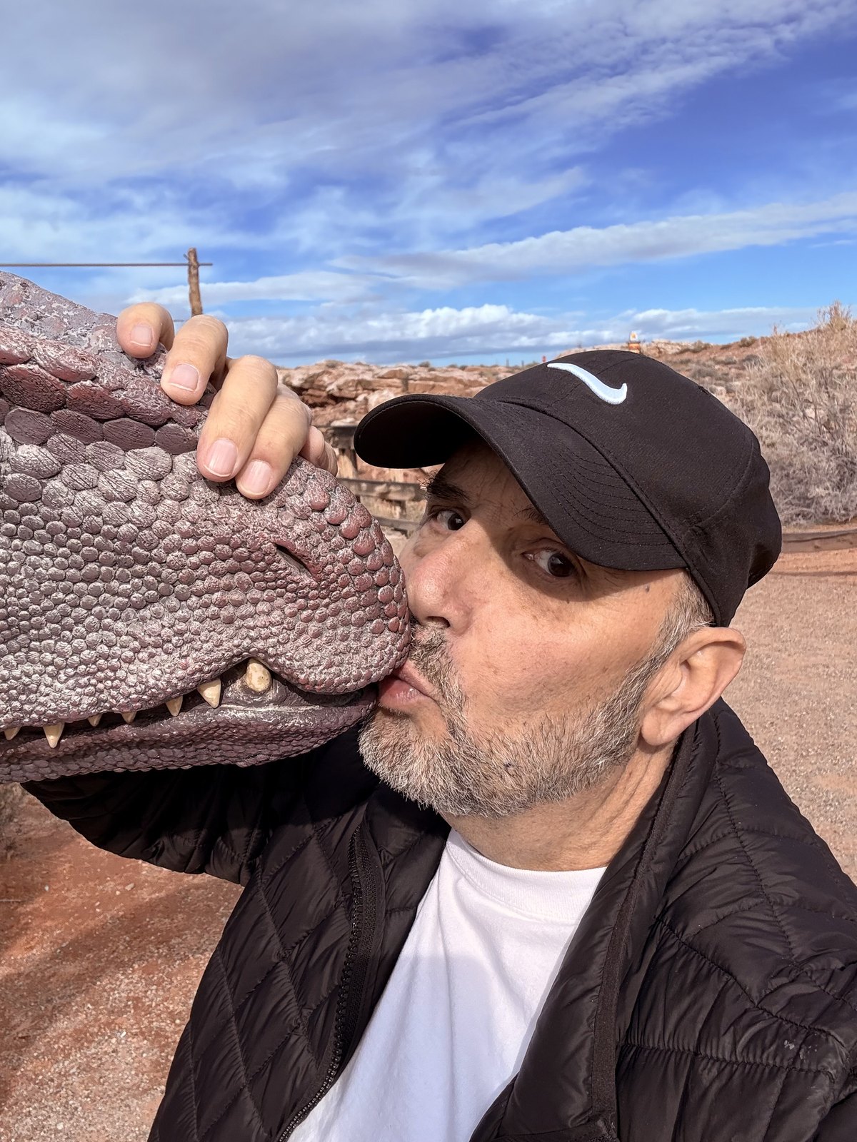 Dino Doug smiling beside a dinosaur head